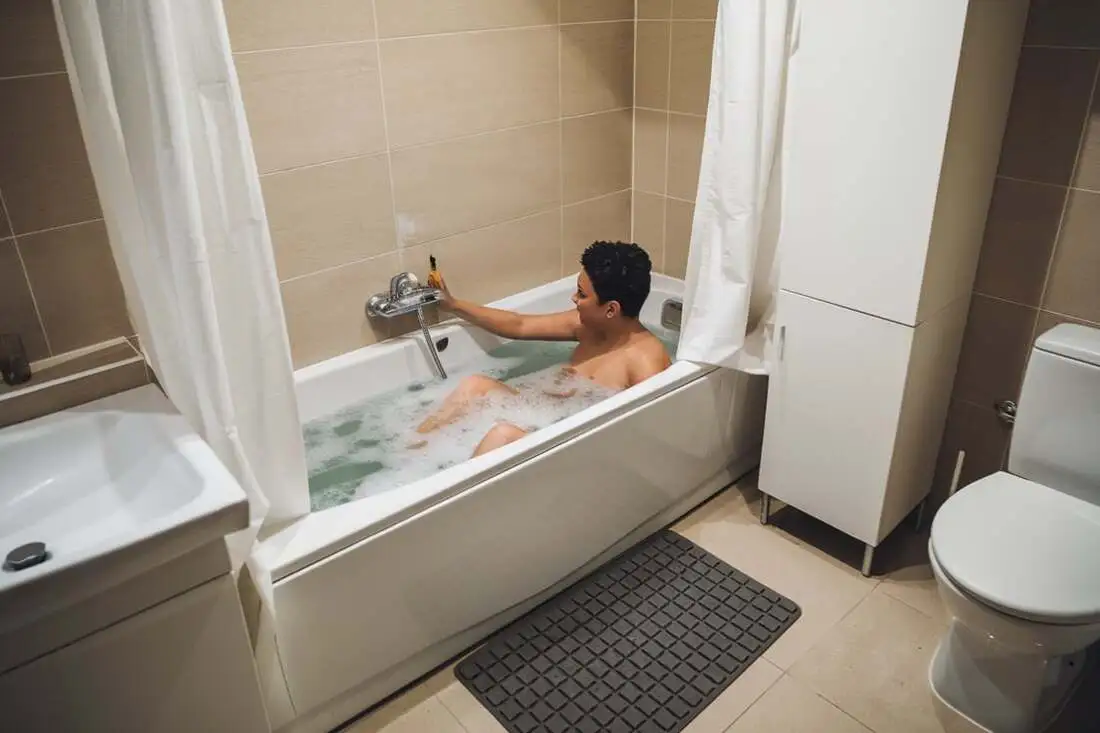 A person engaging in a daily activity taking a warm bath