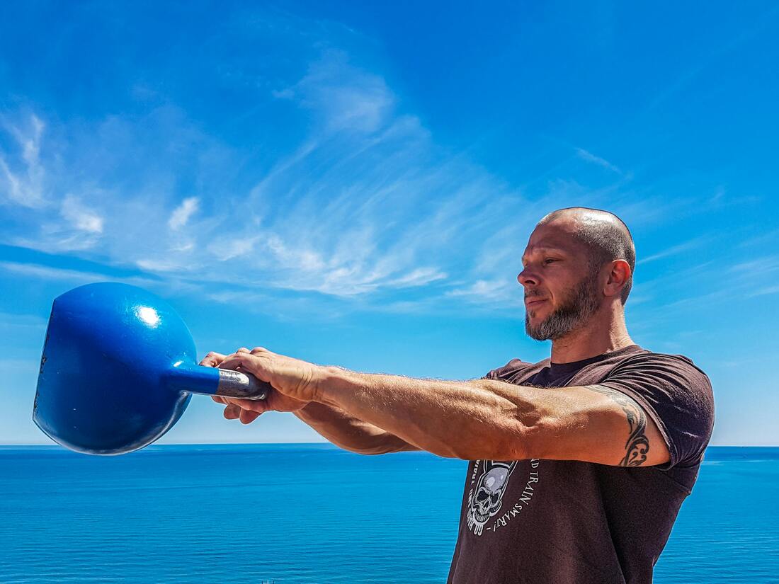 A person performing a high-intensity kettlebell swing with a dynamic background representing HIIT training