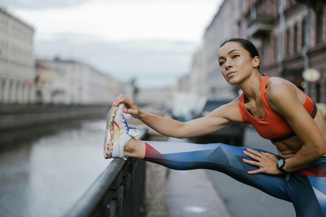 A person stretching their legs after a workout, highlighting the importance of proper warm-up and cool-down routines