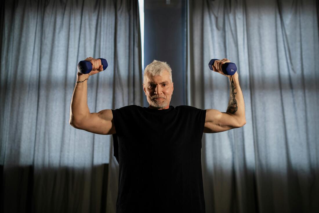 An Elderly Man Lifting Dumbbells