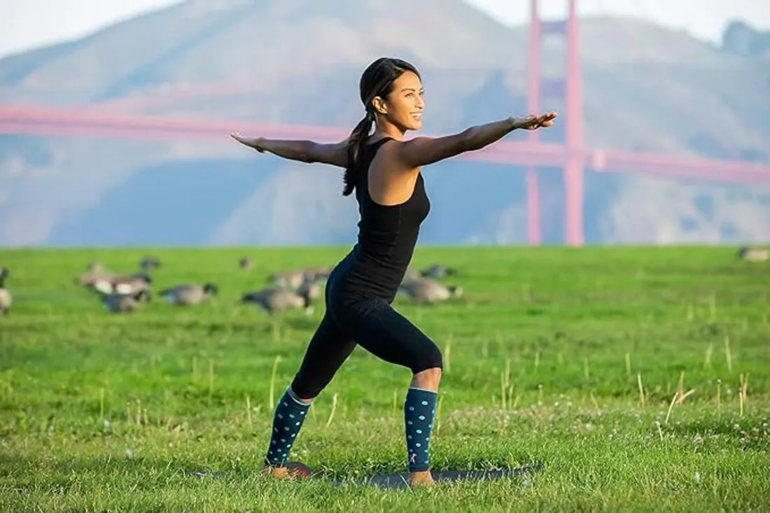 An athlete wearing compression socks while stretching after a workout