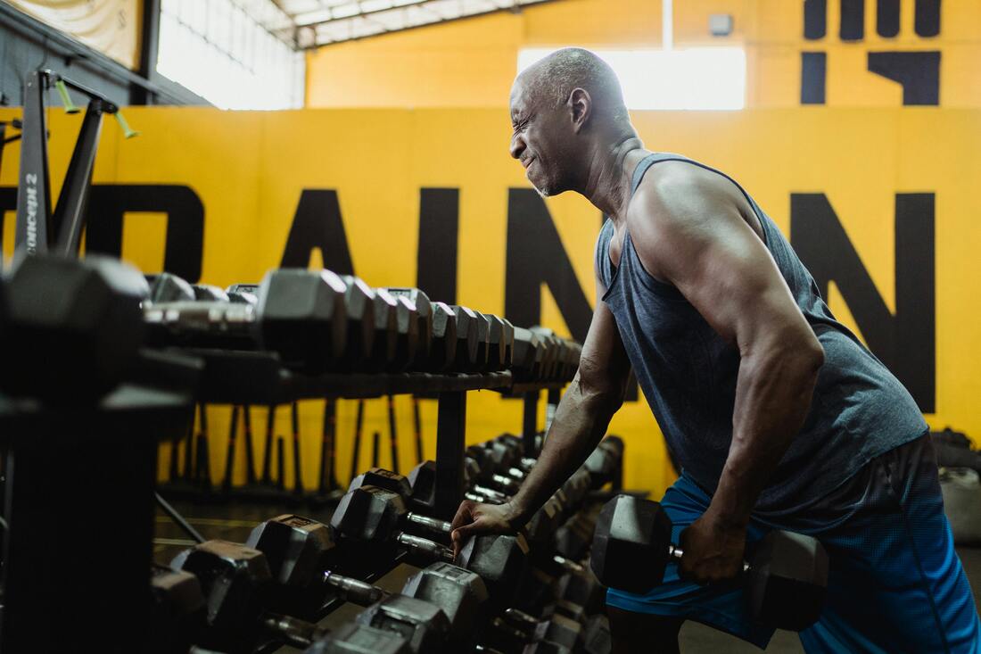 An image of a person hesitantly approaching dumbbells