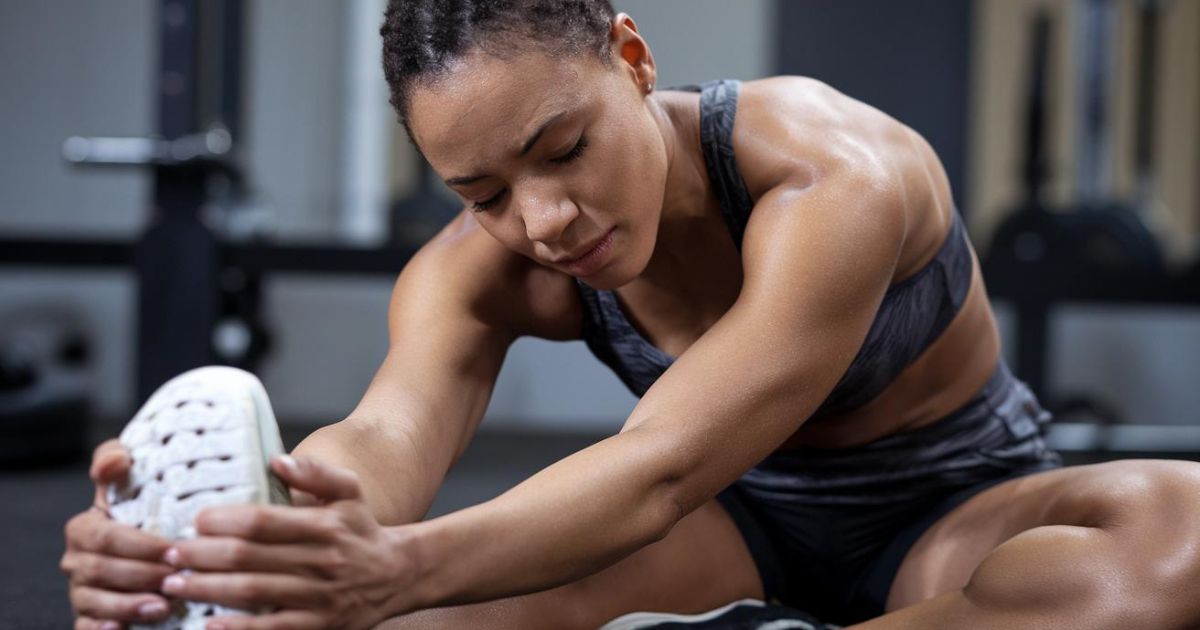 Athlete stretching with a look of relief on their face