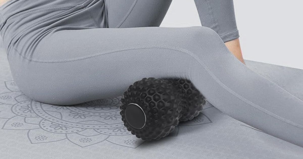 Athlete using peanut massage balls on their back leg