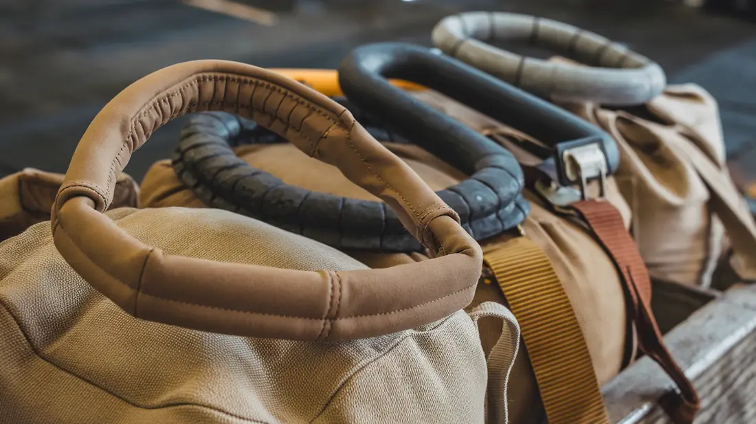 Close-up of various sandbag handles, including padded, reinforced, and hook-and-loop options