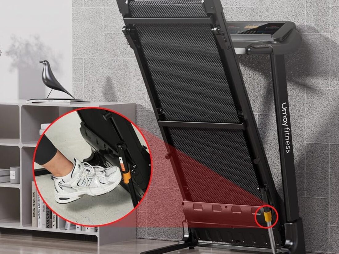 Folding treadmill stored upright in a corner of a room