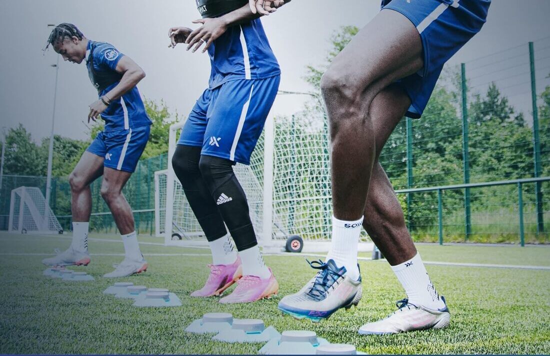 Footballers using a reflex trainer with light bulbs