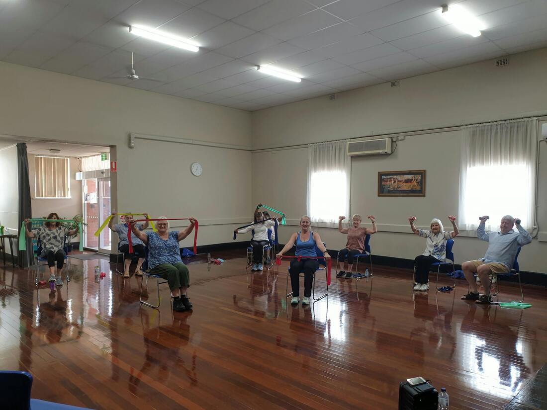 Group of Elderly People Exercising Together