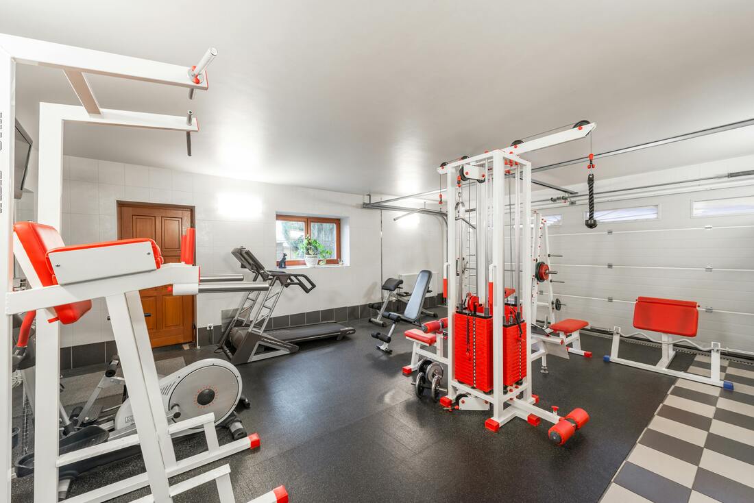 Home gym with equipment on gym flooring