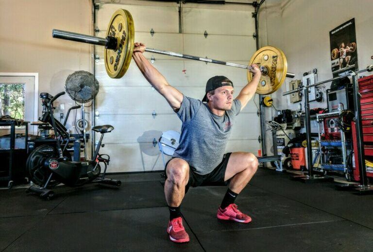 Man carrying weights at home