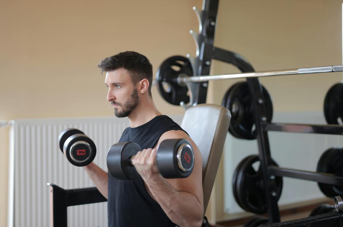 Man with dumbells and barbells for exercise