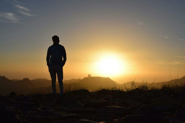 Person looking out at sunrise breathing the fresh air