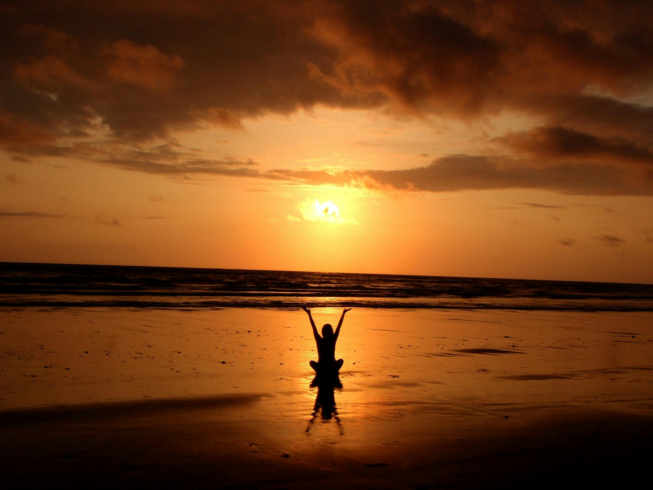 Person practicing deep breathing exercises in a serene outdoor location