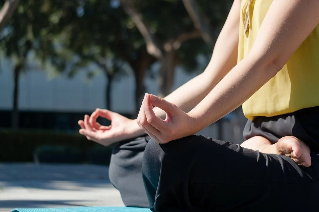 Person practicing yoga or breathing exercises outdoors