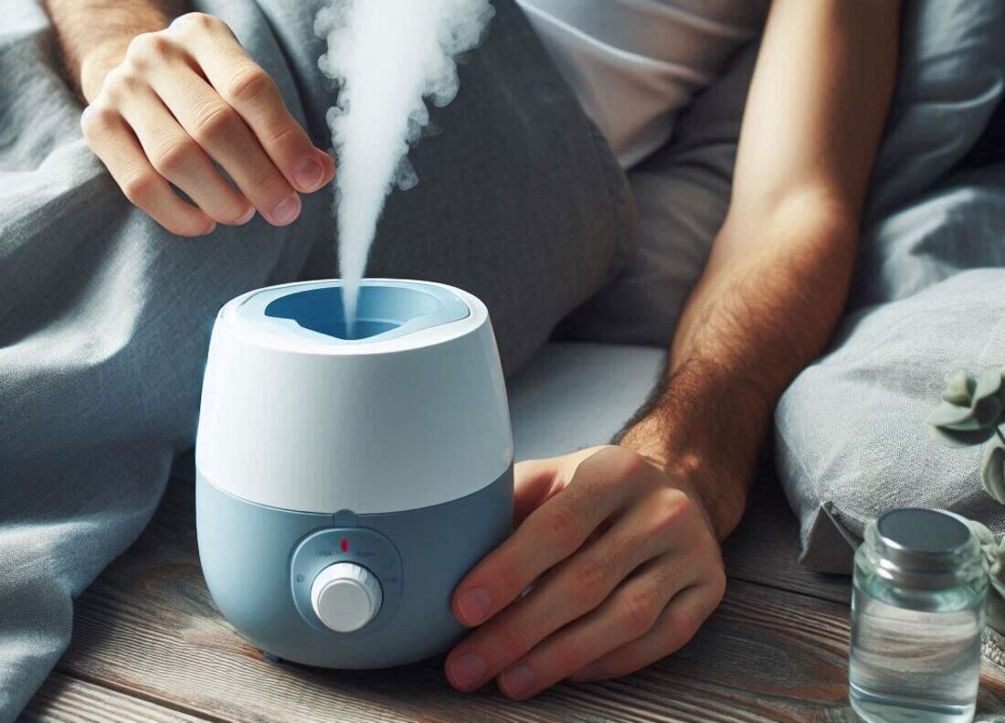 Person using a cool mist humidifier while resting in bed