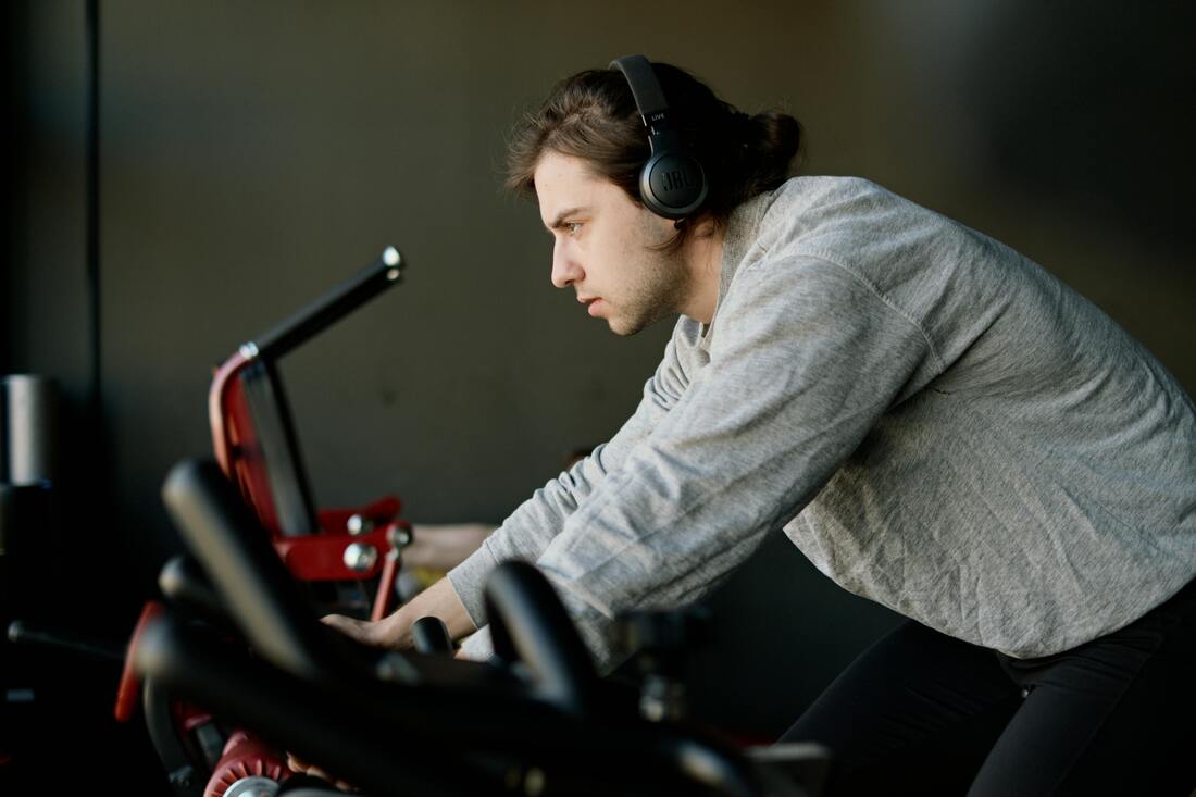 Person using exercise bike for cardio workout