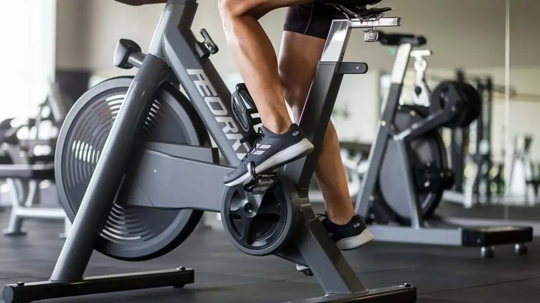 Person doing leg press on Sunny Health & Fitness bike