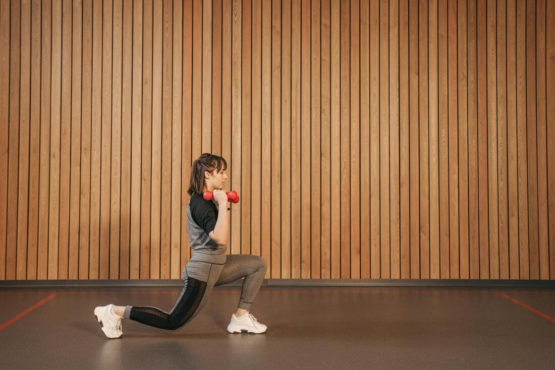 Woman Exercising Lunges with Dumbbells