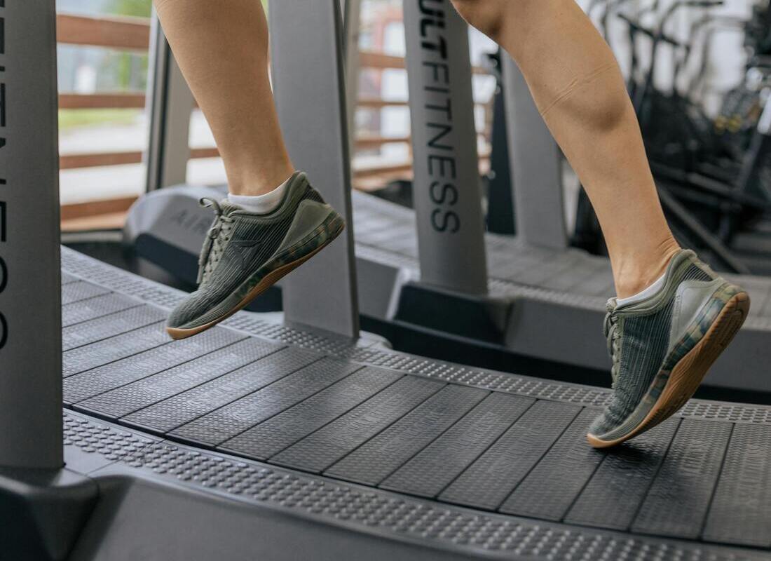 Woman Running on a Curved Treadmill