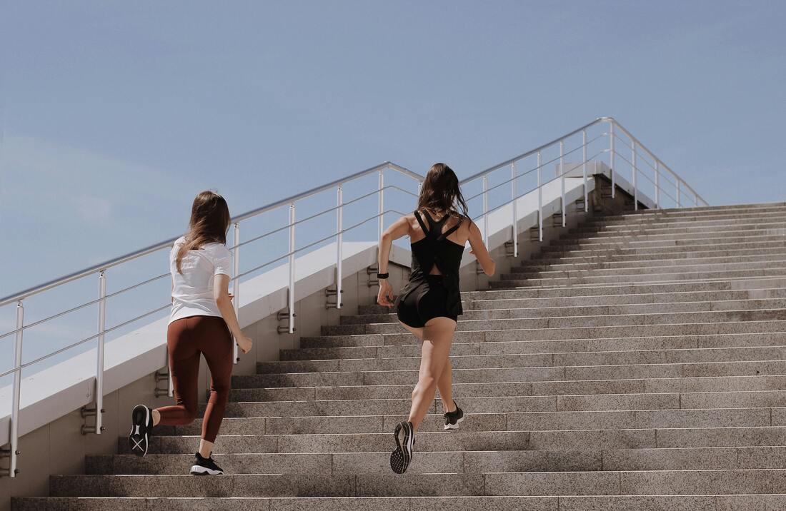 Women running up the stairs