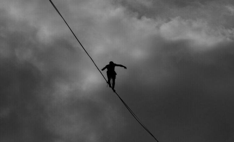 A person confidently walking on a tightrope